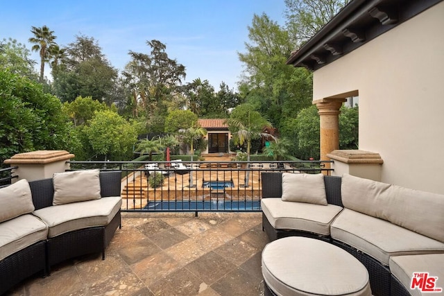 view of patio featuring an outdoor living space and a balcony