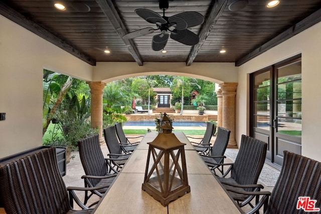 view of patio featuring ceiling fan and an outdoor structure