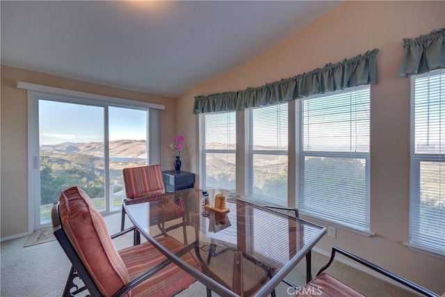 dining area featuring lofted ceiling, a mountain view, and carpet floors