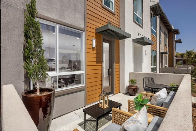 view of patio featuring an outdoor hangout area and a balcony