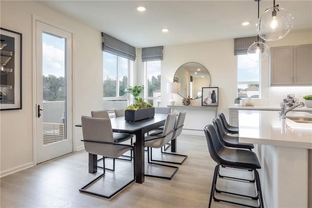 dining room featuring sink and light hardwood / wood-style floors