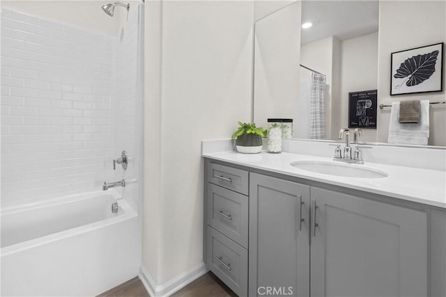 bathroom featuring shower / tub combo and vanity