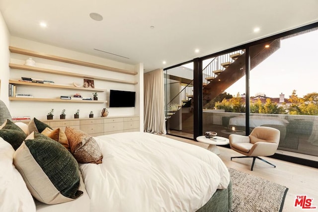 bedroom featuring access to exterior and light hardwood / wood-style flooring