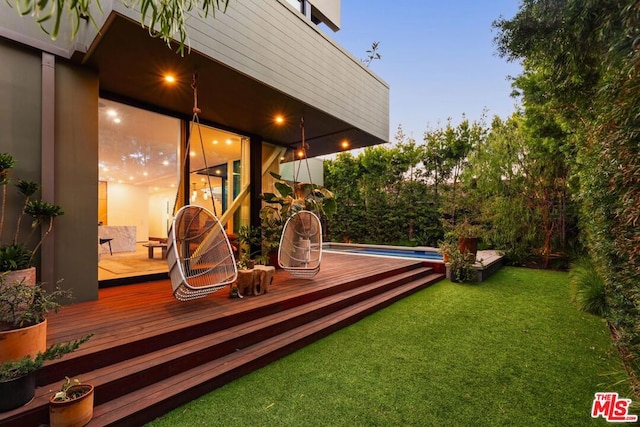 deck at dusk with a yard