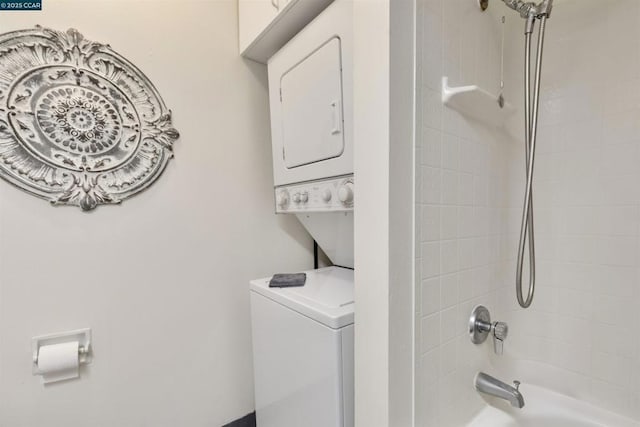 clothes washing area featuring stacked washer and dryer