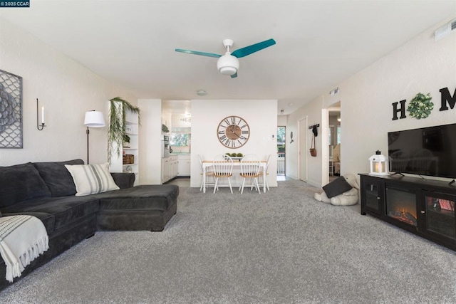 living room featuring ceiling fan and carpet flooring