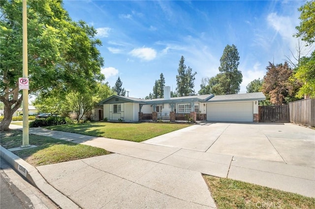 single story home featuring a garage and a front yard