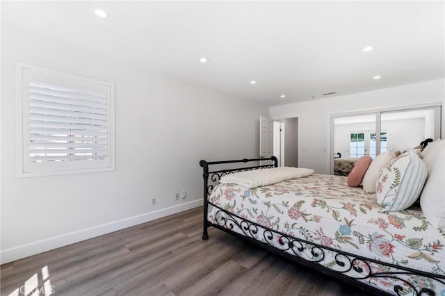 bedroom with wood-type flooring, a closet, and french doors