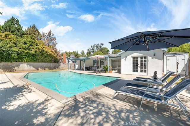 view of pool with a patio area and french doors