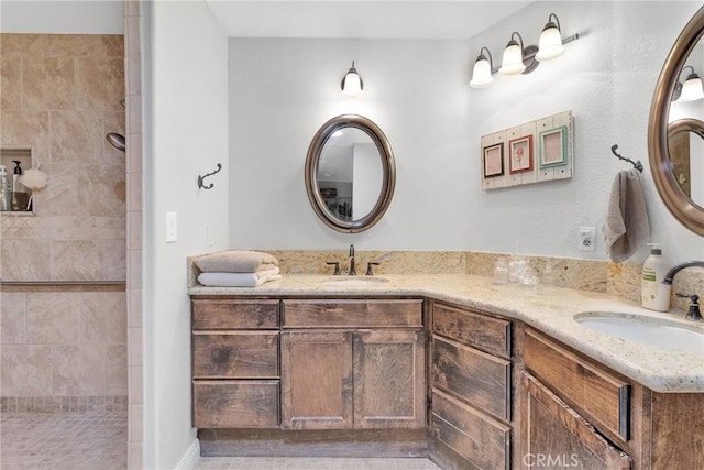 bathroom with vanity and tiled shower