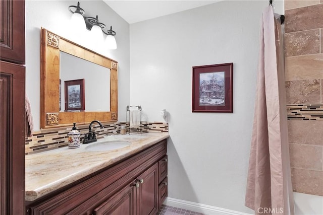 bathroom featuring vanity, backsplash, and a shower with shower curtain