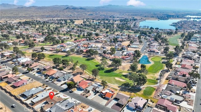 birds eye view of property with a water and mountain view