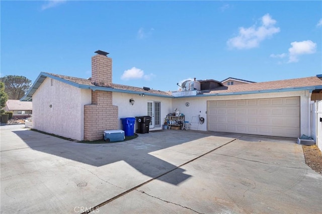 rear view of property with a garage