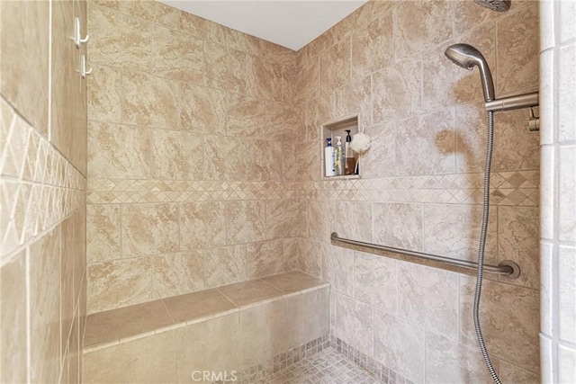 bathroom featuring a tile shower