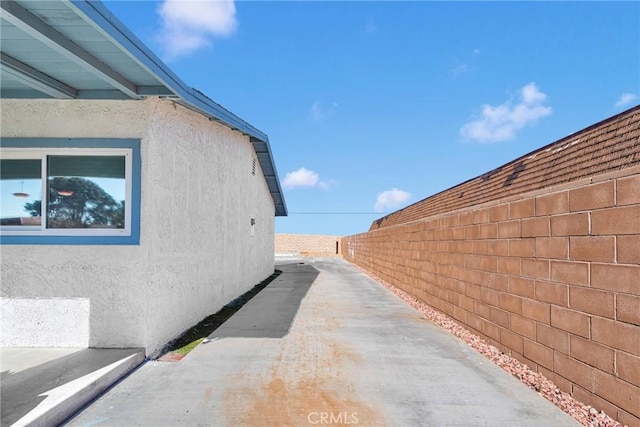 view of property exterior with a patio area