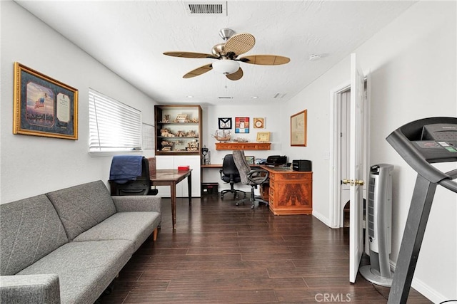 home office with dark wood-type flooring and ceiling fan