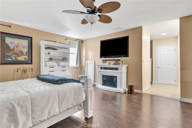 bedroom featuring ceiling fan and dark hardwood / wood-style floors