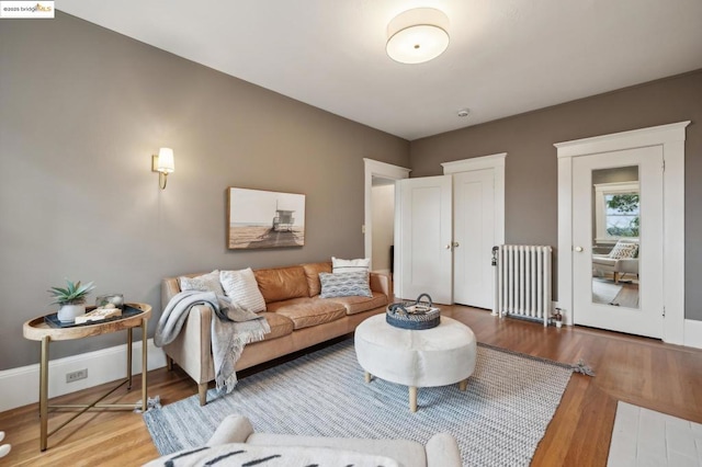 living room featuring hardwood / wood-style flooring and radiator heating unit