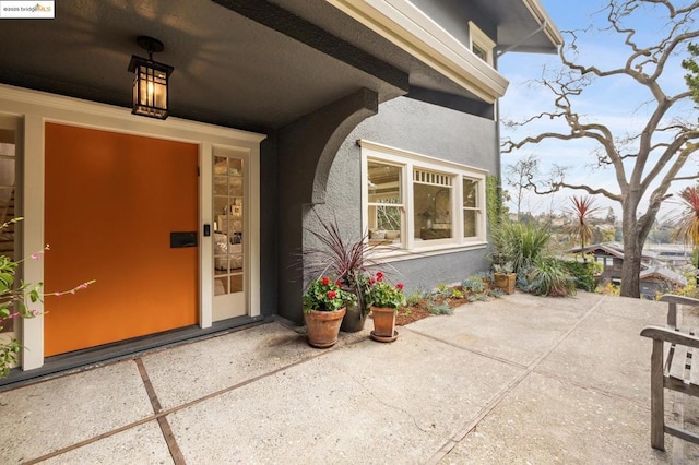 view of exterior entry featuring a patio