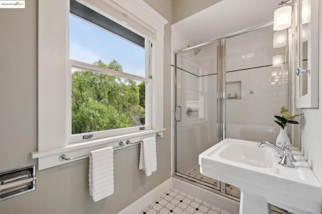 bathroom featuring sink and an enclosed shower