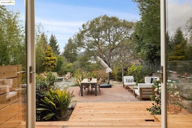 deck with outdoor lounge area and a patio area