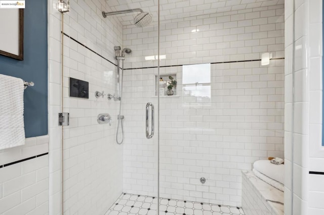 bathroom featuring tile walls and a shower with shower door