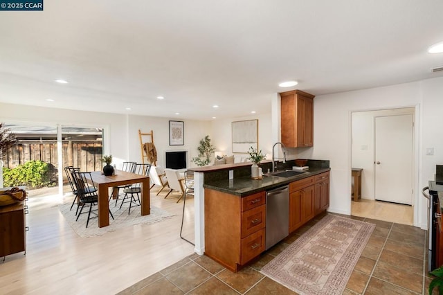 kitchen with dishwasher, sink, and kitchen peninsula