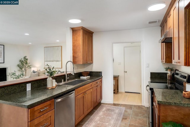 kitchen with tile patterned flooring, appliances with stainless steel finishes, and sink