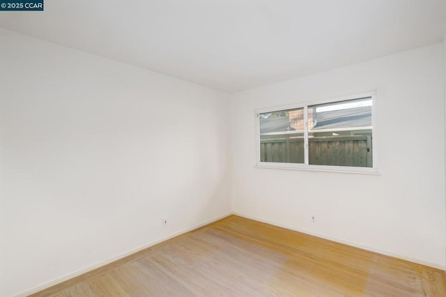 empty room with hardwood / wood-style flooring