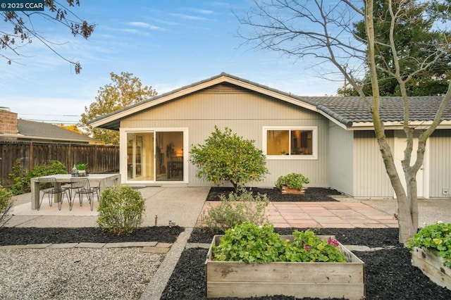 back of house with a patio