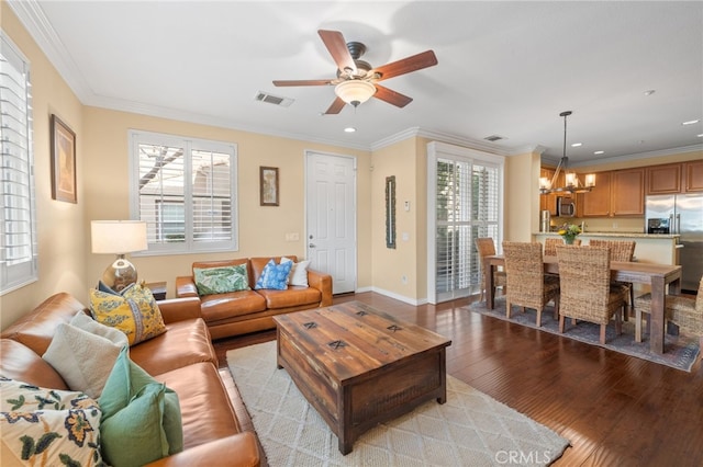 living room with crown molding, a wealth of natural light, light hardwood / wood-style floors, and ceiling fan with notable chandelier