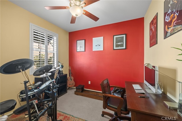 carpeted office space with ceiling fan