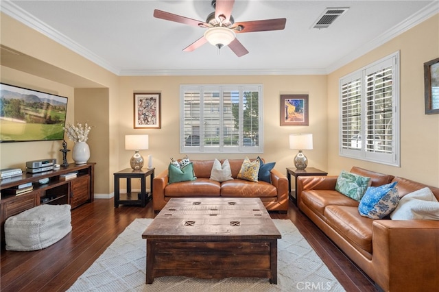 living room with crown molding, plenty of natural light, ceiling fan, and dark hardwood / wood-style flooring