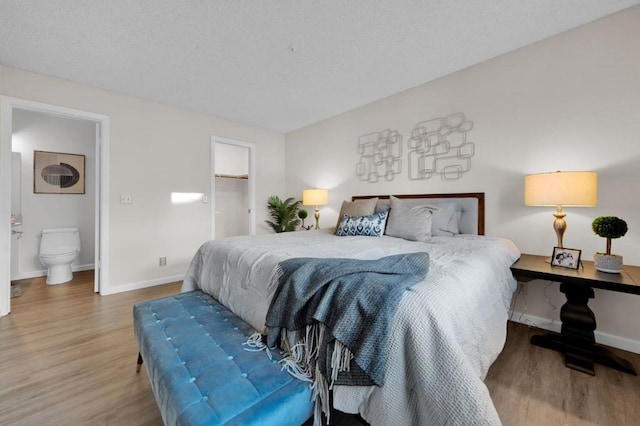 bedroom featuring wood-type flooring and ensuite bathroom