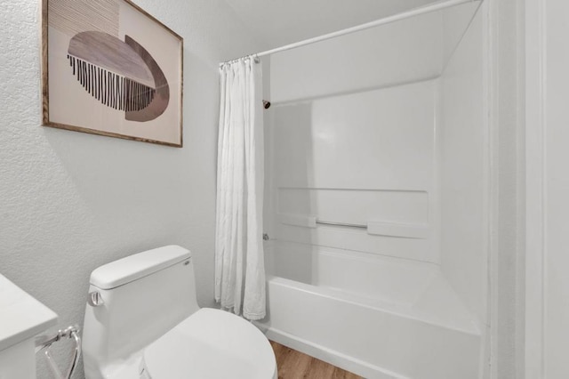 bathroom featuring shower / tub combo with curtain, toilet, and hardwood / wood-style floors