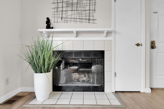 room details with hardwood / wood-style floors and a fireplace