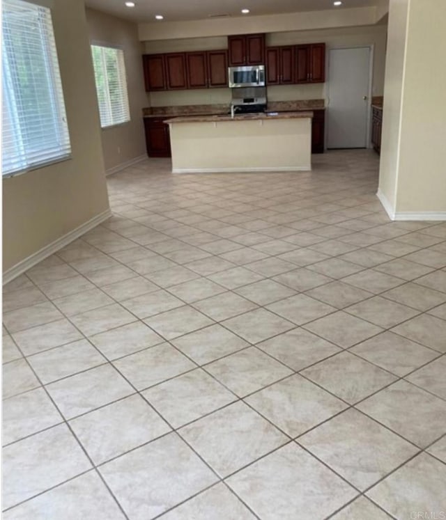 kitchen with stainless steel appliances and a center island with sink