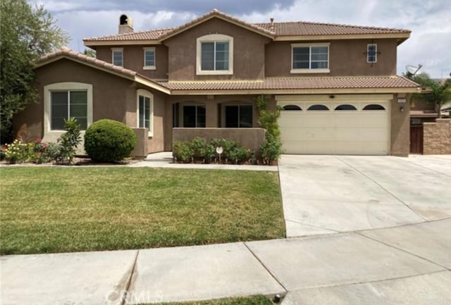 view of front of home featuring a garage and a front lawn