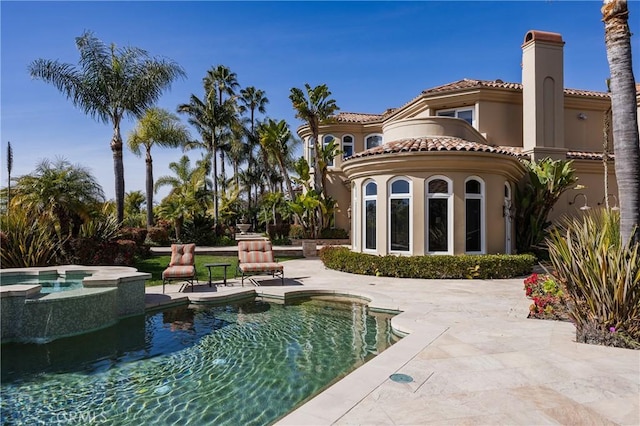 6 Inspiration, Laguna Niguel, CA 92677 - rear view of house featuring a balcony, a chimney, a patio area, stucco siding, and a tile roof