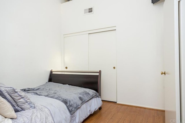 bedroom featuring light hardwood / wood-style floors and a closet