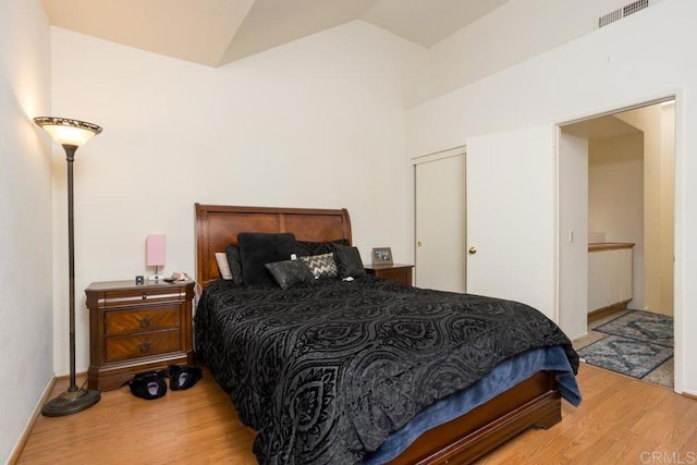 bedroom featuring wood-type flooring and vaulted ceiling