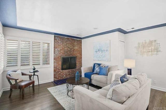 living room featuring dark hardwood / wood-style flooring and a fireplace