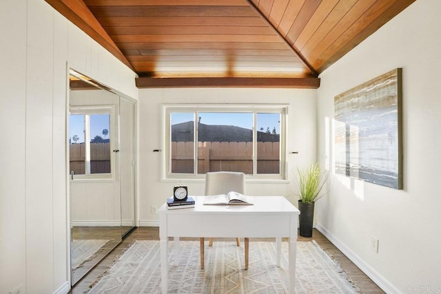 unfurnished office with hardwood / wood-style flooring, vaulted ceiling, a mountain view, and wooden ceiling