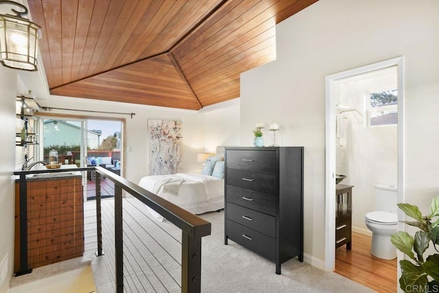 bedroom featuring connected bathroom, vaulted ceiling, and wooden ceiling