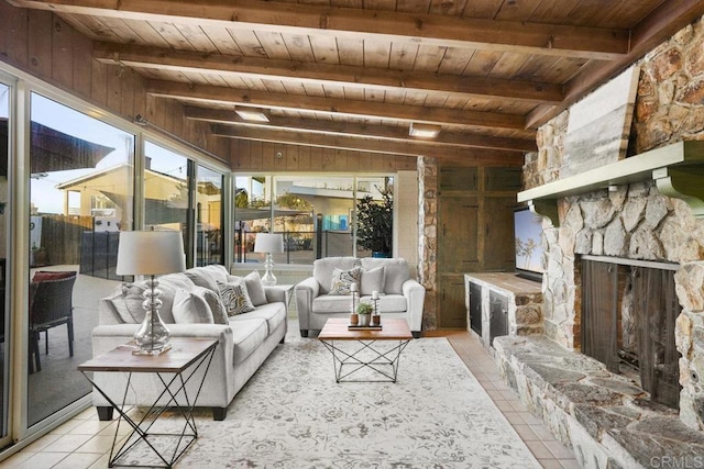 living room with light tile patterned floors, beam ceiling, and wooden ceiling