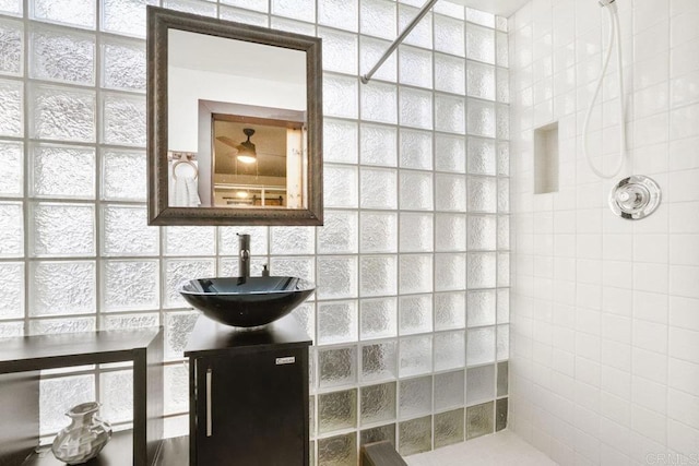 bathroom featuring vanity and a tile shower