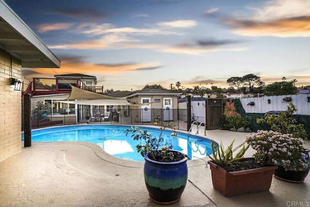 view of pool at dusk