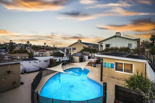 view of pool at dusk