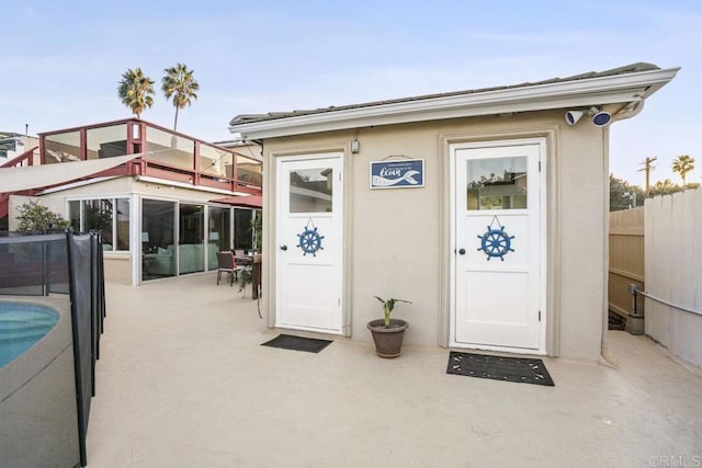 doorway to property featuring a swimming pool and a patio area