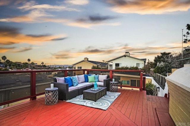 deck at dusk with an outdoor living space